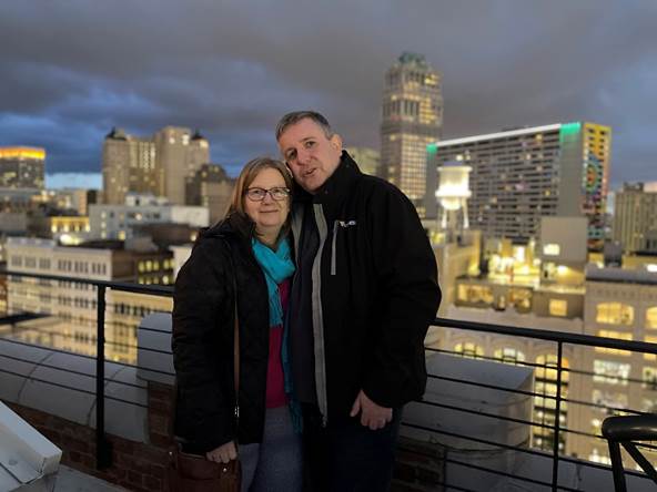 A person and person posing for a picture on a rooftop

Description automatically generated with low confidence